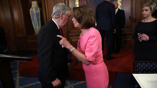 WASHINGTON, DC - DECEMBER 08: U.S. Senate Majority Leader Mitch McConnell (R-KY) speaks with House Minority Leader Rep. Nancy Pelosi (R) (D-CA) following an event marking the passage of the 21st Century Cures Act at the U.S. Capitol December 8, 2016 in Washington, DC. The bill, passed with strong bipartisan support, provides funding for cancer research, the fight against the epidemic of opioid abuse, mental health treatment, aids the Food and Drug Administration in expediting drug approvals and pushes for better use of technology in medicine. (Photo by Win McNamee/Getty Images)