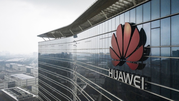 The Huawei Technologies Co. logo is displayed atop an office building at the company's production facility in this aerial photograph taken in Dongguan, China, on Thursday, May 23, 2019. Huawei is seeking about $1 billion from a small group of lenders, its first major funding test after getting hit with U.S. curbs that threaten to cut off access to critical suppliers.