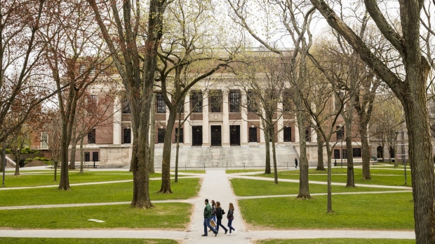 Pedestrians walk through Harvard Yard on the closed Harvard University campus in Cambridge, Massachusetts on April 20. Photographer: Adam Glanzman/Bloomberg