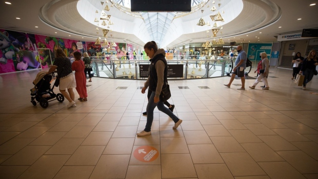 Shoppers follow directions for passing through the Lakeside shopping centre, operated by Intu Properties Plc, in Thurrock, U.K., on Friday, June 19, 2020. U.K. retail sales started to recover last month from their precipitous drop during the coronavirus lockdown. Photographer: Chris Ratcliffe/Bloomberg