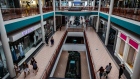 Shoppers walk through a mall in Syracuse, New York on July 10. Photographer: Maranie Staab/Bloomberg