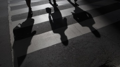 The shadow of pedestrians are seen on the ground of a crosswalk in Toronto, Ontario, Canada, on Friday, May 19, 2017.