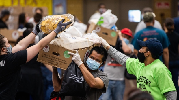 A person wearing a protective mask receives groceries at a Catholic Charities Brooklyn and Queens pop-up food pantry in the Brooklyn borough of New York on May 29.
