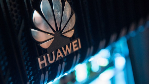 A corporate logo sits on a Huawei Technologies Co. NetEngine 8000 intelligent metro router on display during a 5G event in London. Photographer: Chris Ratcliffe/Bloomberg