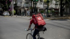 A worker rides a bicycle while making a Cornershop app delivery in Mexico City, Mexico, on Friday, April 3, 2020. As the coronavirus pandemic strangles economies and throws people out of work, food delivery drivers are competing for orders.