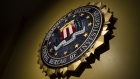 The seal of the Federal Bureau of Investigation (FBI) hangs on a wall before a news conference at the FBI headquarters in Washington, D.C., U.S., on Thursday, June 14, 2018. Former FBI Director James Comey was "insubordinate" in handling the probe into Hillary Clinton, damaging the bureau and the Justice Department's image of impartiality even though he wasn't motivated by politics, the department's watchdog said today. Photographer: Al Drago/Bloomberg