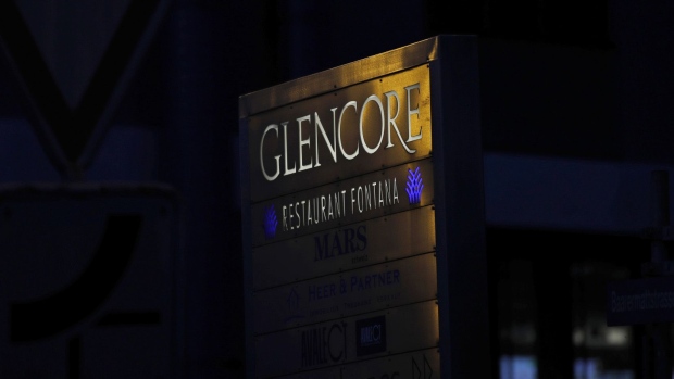 Light reflects on signage at sunset near the Glencore Plc headquarters office in Baar, Switzerland.