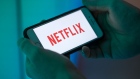 The logo for Netflix Inc. sits on an Apple Inc. iPhone smartphone.