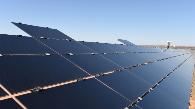 Two test panels sit mounted above an array of solar panels at the Broken Hill Solar Plant, operated by AGL Energy Ltd. and constructed by First Solar Inc., in Broken Hill, Australia, on Wednesday, Dec. 9, 2015.