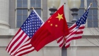 Flags of the U.S. and China fly along Pennsylvania Avenue in Washington, D.C., U.S..