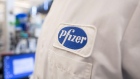 The Pfizer logo on the lab coat of an employee at the company's research and development facility in Cambridge, Massachusetts. 