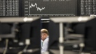 Traders monitor financial data as the second iteration of the Markets in Financial Instruments Directive (MiFID II) comes into force, as the DAX Index curve is displayed beyond at the Frankfurt Stock Exchange, operated by Deutsche Boerse AG, in Frankfurt, Germany, on Wednesday, Jan. 3, 2018. After seven years of preparation, $2 billion in compliance costs and one false start, the biggest shake-up to European regulation in a decade is finally here.