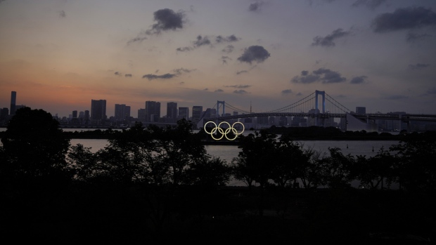 Illuminated Olympic rings float in the waters off Odaiba island in Tokyo. Bloomberg
