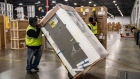 A worker prepares to load a Whirlpool Corp. refrigerator onto a delivery truck at a distribution center in Wilmer, Texas, U.S., on Thursday, Dec. 27, 2018. J.B. Hunt Transport Services Inc. is announcing Wednesday that it has agreed to pay $100 million for a New Jersey company that delivers large items to consumers, its second purchase in the space in less than two years. Photographer: Sergio Flores/Bloomberg