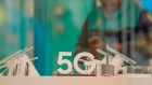 A sign advertising 5G network-enable phones sits on display inside a EE mobile phone store, operated by BT Group Plc, in Reading, U.K. on Monday, July 13, 2020. U.K. Prime Minister Boris Johnson is under pressure to announce a ban on telecoms companies from installing new equipment made by Huawei Technologies Co. in Britain's fifth-generation mobile networks from as soon as the end of 2021.