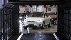 A Tesla Model X sports utility vehicle (SUV) drives into a rain testing chamber during assembly for the European market at the Tesla Motors Inc. factory in Tilburg, Netherlands, on Friday, Dec. 9, 2016. A boom in electric vehicles made by the likes of Tesla could erode as much as 10 percent of global gasoline demand by 2035, according to the oil industry consultant Wood Mackenzie Ltd.