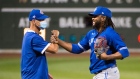 Rafael Dolis, right, of the Toronto Blue Jays celebrates with a member of the coaching staff during a game on July 21.