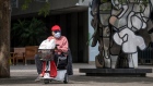 A person wearing a protective mask rides a mobility scooter in San Francisco, California, U.S. Photographer: David Paul Morris/Bloomberg