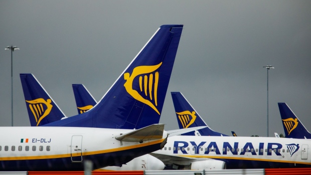 Tail-fins of passenger aircraft bearing the livery of Ryanair Holdings Plc stand on the tarmac at London Stansted Airport, operated by Manchester Airport Plc, in Stansted, U.K., on Thursday, July 9, 2020. EasyJet Plc is considering cutting a third of its pilot positions and may eliminate three bases in the U.K., including London's Stansted airport, in reaction to a business slump that the discount carrier doesn’t expect to rebound for another three years. Photographer: Luke MacGregor/Bloomberg