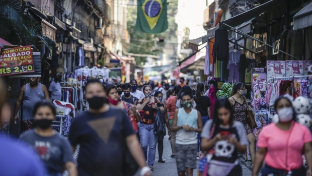 Pedestrians wearing protective masks walk on Alfandega Street in Rio de Janeiro. Photographer: Andre Coelho/Bloomberg