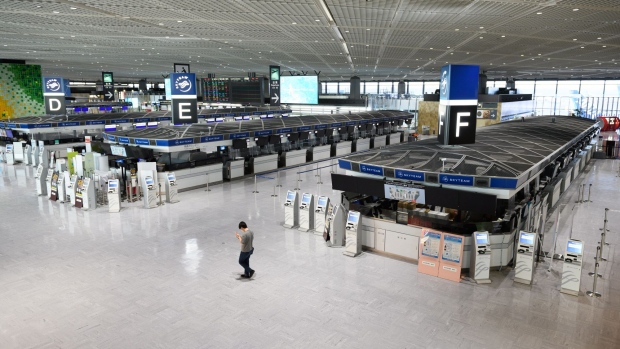 A man walks through a near-empty departures hall of Narita Airport in Narita, Chiba Prefecture, Japan, on July 19.