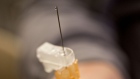 Liquid vaccine flows from a flu shot a hospital.