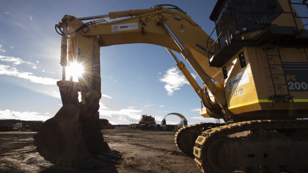 An excavator sits in a workshop area of the St Ives Gold Mine operated by Gold Fields Ltd. in Kambalda, Australia, on Wednesday, Aug. 9, 2017. Global gold deals have also slowed, declining to $19.8 billion in 2016 from $22.8 billion a year earlier, according to data complied by Bloomberg.