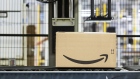 The Amazon.com Inc. logo sits on a box as it passes along a conveyor inside the company's fulfilment center in Koblenz, Germany, on Friday, Nov. 23, 2018. Germans are expected to buy about 2.4 billion euros worth of goods on Black Friday and Cyber Monday, an increase of about 15 percent over last year. Photographer: Alex Kraus/Bloomberg
