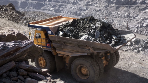 A dump truck transports iron ore at the open pit mine, operated by ArcelorMittal, in Kryvyi Rih, Ukraine, on Wednesday, March 6, 2019. ArcelorMittal has made an offer of 48 billion rupees ($672 million) to buy an Essar Power generation plant in India, outbidding the founding Ruia brothers, according to people with knowledge of the matter. Photographer: Vincent Mundy/Bloomberg