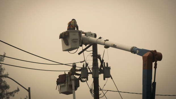 Pacific Gas & Electric Co. (PG&E) workers repair a transformer in Paradise, California, U.S., on Thursday, Nov. 15, 2018. The number of acres burned in the blazes -- including the Hill and Woolsey fires in Southern California, and the Camp fire in Northern California, which has killed at least 48 people and destroyed the city of Paradise -- already is higher than the total burned in wildfires last year, A.M. Best Co. wrote in a report late Tuesday.