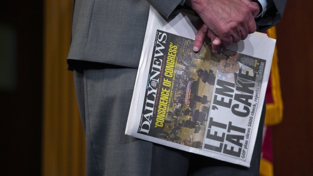 Senate Minority Leader Chuck Schumer, a Democrat from New York, holds a copy of the New York Daily News newspaper during a news conference at the U.S. Capitol in Washington, D.C., U.S., on Tuesday, July 28, 2020. The two parties in Congress staked out battle lines over liability protections for employers and jobless benefits ahead of another round of negotiations Tuesday between Democratic leaders and President Donald Trumps representatives.