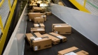 Boxes move along a conveyor belt at the Amazon.com Inc. fulfillment center on Cyber Monday in Robbinsville, New Jersey, U.S., on Monday, Nov. 30, 2015.