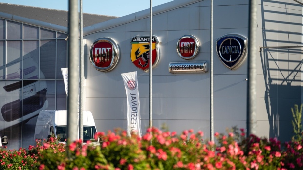 Logos of marquees of Fiat Chrysler Automobiles NV sit on the Mirafiori Motor Village dealership in Turin, Italy, on Monday, June 22, 2020. Italy is close to approving a 6.3 billion-euro ($7.1 billion) credit facility for Fiat Chrysler Automobiles NV, setting the stage for Europe’s biggest government-backed financing to a carmaker since the start of the coronavirus pandemic, according to people familiar with the matter. Photographer: Federico Bernini/Bloomberg