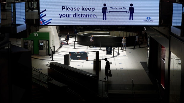 A social distancing sign is displayed inside the Eaton Centre in Toronto, Ontario, Canada, on Wednes