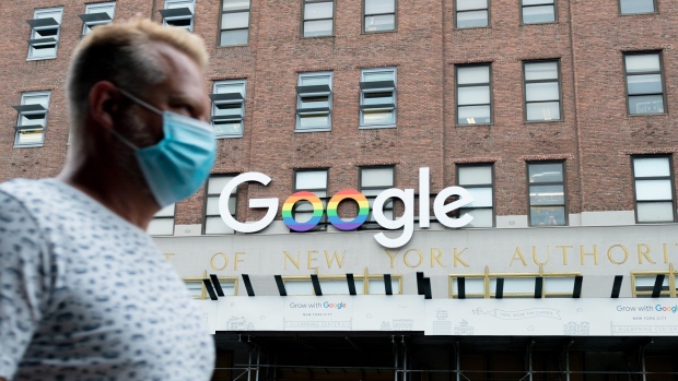 NEW YORK, NEW YORK - JULY 30: A man wearing a mask walks past the Google officers in Chelsea as the city continues Phase 4 of re-opening following restrictions imposed to slow the spread of coronavirus on July 30, 2020 in New York City. The fourth phase allows outdoor arts and entertainment, sporting events without fans and media production. (Photo by Alexi Rosenfeld/Getty Images)