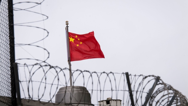 A Chinese flag flies outside the China Consulate General building in San Francisco, California, U.S., on Thursday, July 23, 2020. A Chinese researcher at the University of California at Davis who was charged with lying about her military service has taken shelter at the Chinese consulate in San Francisco, according to court filings.