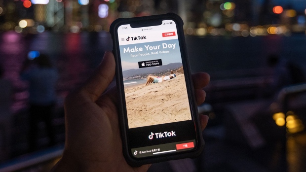 The website for ByteDance Ltd.’s TikTok app is arranged for a photograph on a smartphone in Hong Kong, China, on Tuesday, July 7, 2020. TikTok will pull its viral video app from Hong Kong's mobile stores in coming days, becoming the first internet service to withdraw after Beijing enacted sweeping powers to crack down on national security threats. Photographer: Roy Liu/Bloomberg