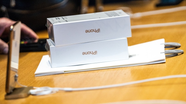 Apple Inc. iPhone XS boxes sit on a counter during a sales launch at a store in New York, U.S., on Friday, Sep. 21, 2018. The iPhone XS is up to $200 more expensive than last year's already pricey iPhone X and represents one of the smallest advances in the product line's history. But that means little to the Apple Inc. faithful or those seeking to upgrade their older iPhone. Photographer: Jeenah Moon/Bloomberg
