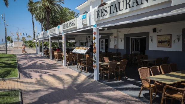 Empty tables sit in the outdoor terrace area of a restaurant by the beach in Salou, Spain, on Monday, July 27, 2020. Spain's tourism industry is at increasing risk of being shut down as countries across Europe seek to restrict visits to the Mediterranean nation, following an order by the British government to quarantine visitors.