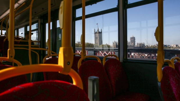 The Houses of Parliament stand in this view from inside a bus in London, U.K., on Wednesday, April 22, 2020. Boris Johnson's coronavirus strategy faces its first major political test since the U.K. was put on lockdown a month ago when members of Parliament question ministers in a sitting conducted via video-conference.