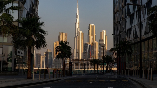 The Burj Khalifa skyscraper, center, stands beyond an empty road among other office buildings on the city skyline seen from Dubai Design District in Dubai, United Arab Emirates, on Tuesday, June 9, 2020. “An exodus of middle class residents could create a death spiral for the economy,” said Ryan Bohl, a Middle East analyst at Stratfor.” Photographer: Christopher Pike/Bloomberg