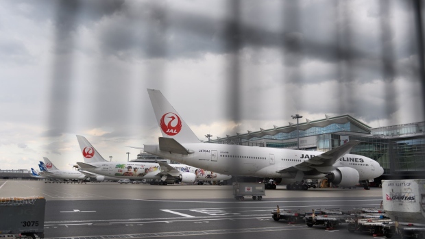Japan Airlines Co. (JAL) aircraft stand at Haneda Airport in Tokyo, Japan, on Thursday, April 23, 2020. Japan’s major airlines are on track to see revenue drop by 500 billion yen ($4.6 billion) from February through May, an industry group said, pushing ANA Holdings Inc.and Japan Airlines Co. closer to the crisis ensnaring other global carriers because of the coronavirus pandemic.