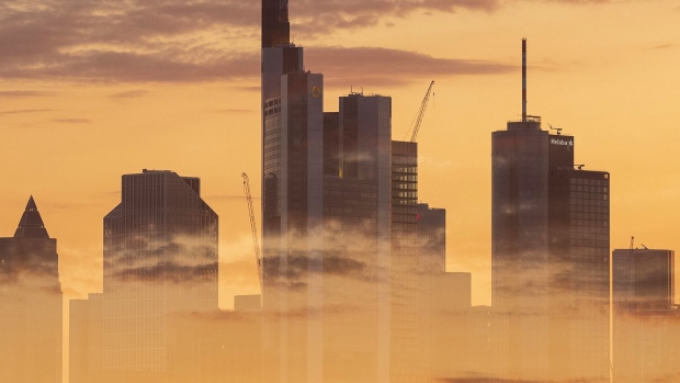 EDITORS NOTE: Multiple exposures were combined in camera to produce this image. An image of clouds at sunset overlays the skyscraper skyline of the financial district in Frankfurt, Germany, on Monday, July 1, 2019. Following the collapse of merger talks between Deutsche Bank and Commerzbank, German Finance Minister Olaf Scholz changed his message from supporting a national champion to backing a cross-border merger.