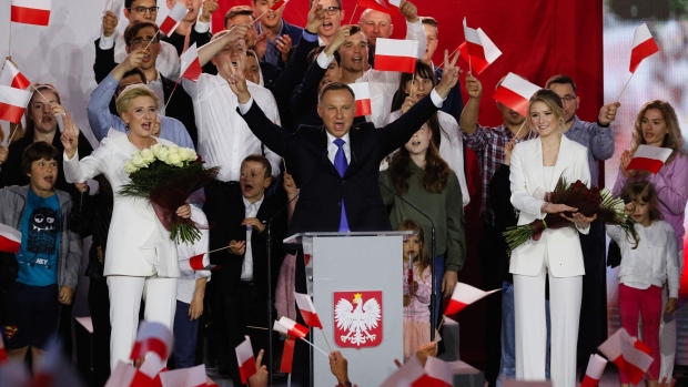 Andrzej Duda, Poland's president and Law & Justice (Pis) candidate, center, speaks flanked by his wife Agata Kornhauser Duda and daughter Kinga Duda as exit polls are announced near Pultusk Castle in Pultusk, Poland, on Sunday, July 12, 2020. Duda and his opposition challenger Rafal Trzaskowski both declared victory in Poland’s presidential election runoff after an exit poll showed the incumbent winning by a razor-thin margin.