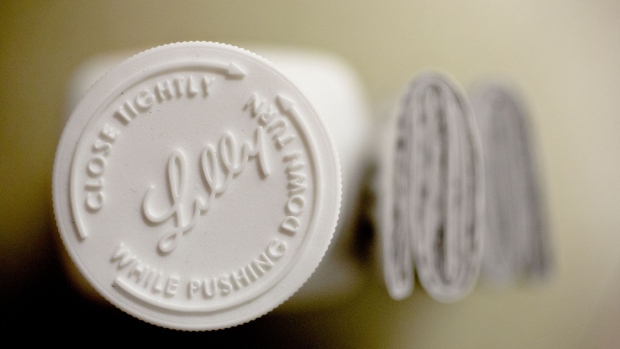 An Eli Lilly & Co. logo is seen on the cap of a pill bottle in this arranged photograph at a pharmacy in Princeton, Illinois, U.S., on Monday, Oct. 23, 2017. Eli Lilly is scheduled to release earnings figures on October 24. Photographer: Daniel Acker/Bloomberg