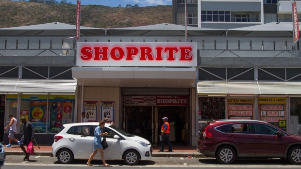 Pedestrians pass the entrance to a Shoprite Holdings Ltd. store in Cape Town, South Africa, on Wednesday, Dec. 21, 2016. South Africa was a bright spot for banks on the continent in 2016, with stocks shrugging off the nation's economic woes to head for the third-best performance in the past decade. Photographer: Dean Hutton/Bloomberg