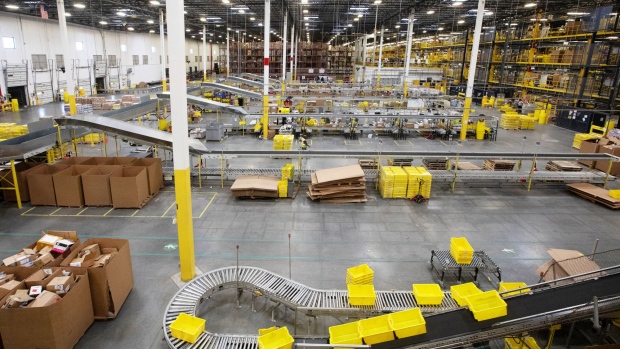 Plastic crates move along a conveyor at the Amazon.com fulfillment center in Robbinsville, New Jersey. Photographer: Bess Adler/Bloomberg