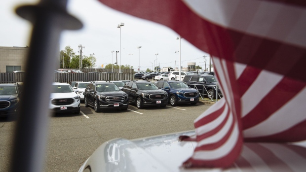 Vehicles are displayed for sale at a General Motors Co. Buick and GMC car dealership. Photographer: Angus Mordant/Bloomberg