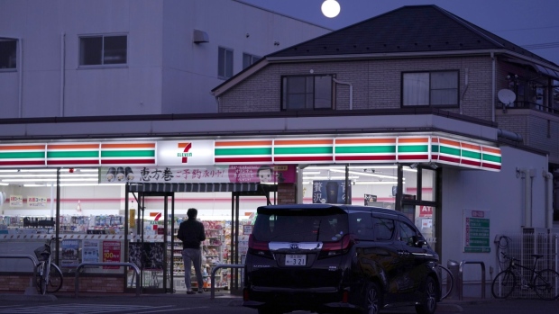 Customers enter a 7-Eleven convenience store, operated by Seven & i Holdings Co., in Tokyo, Japan, on Monday, June 17, 2019. The Japan Franchise Association will release sales figures on nationwide convenience stores on June 20. Photographer: James Whitlow Delano/Bloomberg