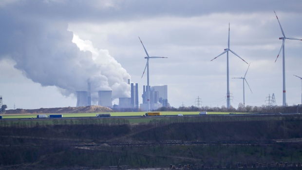Wind turbines operate near the Neurath lignite fueled power station, operated by RWE AG, in Neurath, Germany, on Tuesday, March 3, 2020. Germany could close its last coal-fired power plant long before a 2038 deadline as the dirtiest fossil fuel gets squeezed out of the energy mix by clean electricity. Photographer: Alex Kraus/Bloomberg